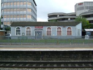 The single-storey, Victorian, wooden building known as 'The Manor' facing Platform One of Slough railway station, with the two unusually-shaped office blocks behind.