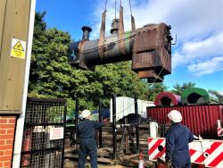 boiler being lifted by strops suspended from a mobile crane in cradle