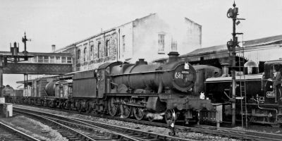 Steam-hauled freight train passing through Swindon station
