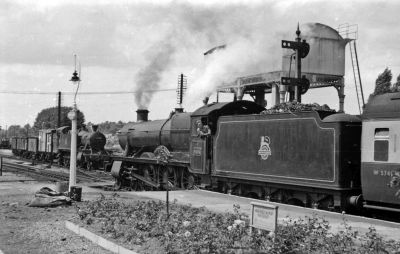 Busy railway station with passenger and freight trains