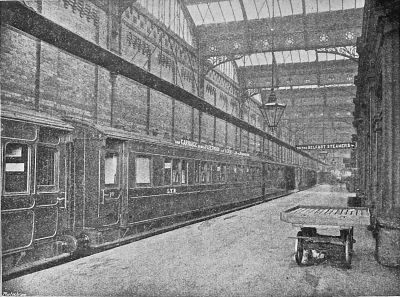Boat train of wooden bogie carriages in a large victorian train shed (1901)