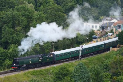 Streamlined (unrebuilt) Battle of Britain class loco pulling a passenger train at Corfe Castle station