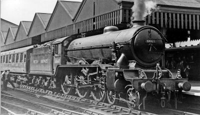 B17 class 4-6-0 steam locomotive at head of a passenger train in a station