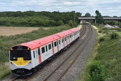 Vivarail Class 230 train on a double track railway line in the countryside