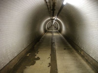 Interior of the Woolwich Foot Tunnel, London – Rob Smith View down a long illuminated foot tunnel