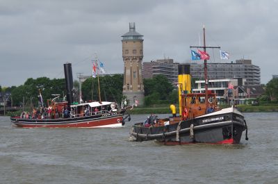 Steam-powered tug boats at the Dordrecht Steam Festival 'Dordt in Stoom' in Holland: the 'Scheelenkuhlen', and the 1893-built 'Pieter Boele' – May 2022 – Colin Miell Two fully restored steam-powered tug boats of vintage design on a wide waterway.