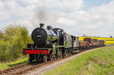 Somerset & Dorset Joint Railway Class 7F 2-8-0 no. 53808 hauling the demonstration freight train between Ropley and Alresford on the Mid-Hants Railway, 29th April 2023. (Tony Storey) A 1920s British steam locomotive designed for freight work (S&DJR Class 7F 2-8-0) hauling a demonstration goods train on a slight embankment in the Hampshire countryside.