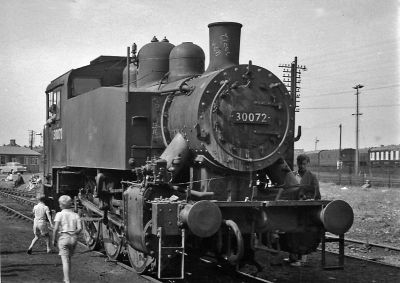 Archive photo of a compact six-coupled tank locomotive sitting in a yard.