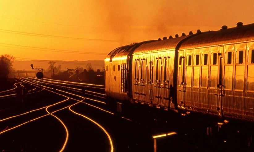 Sunset scene featuring a Class 50 diesel locomotive hauling BR Mk 1 coaches.