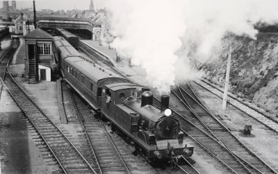Adams O2 tank engine leaves Plymouth Friary station with a short passenger train
