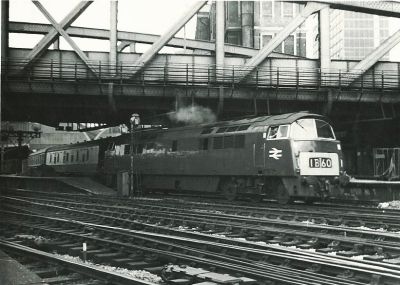 Western class diesel locomotive on passenger train, leaving Paddington station