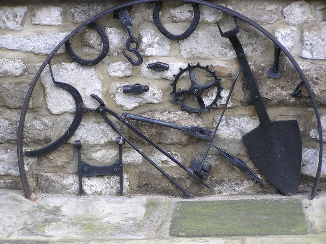 Farm Tools: Hilton Village, County Durham (Hugh Mortimer) – 01 Jan 2003 – Geograph via Wikimedia Commons Vintage farm tools mounted on a stone wall