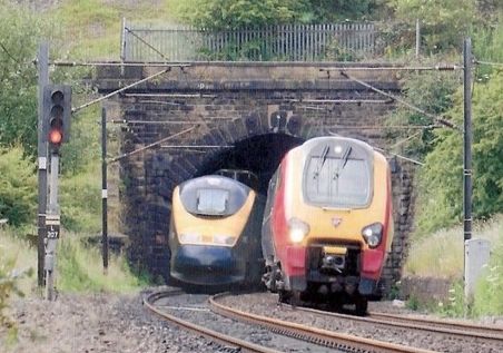 Electric trains passing at a tunnel mouth