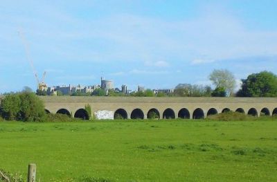 Brick viaduct of Slough to Windsor branch line with Windsor Castle in the background.